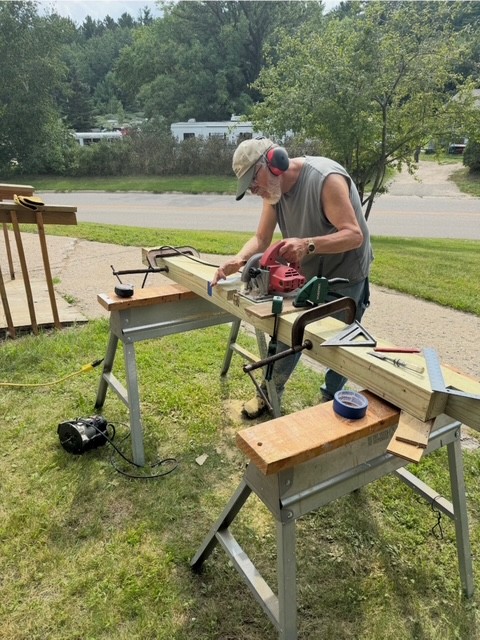 Volunteer doing carpentry work on saw horses