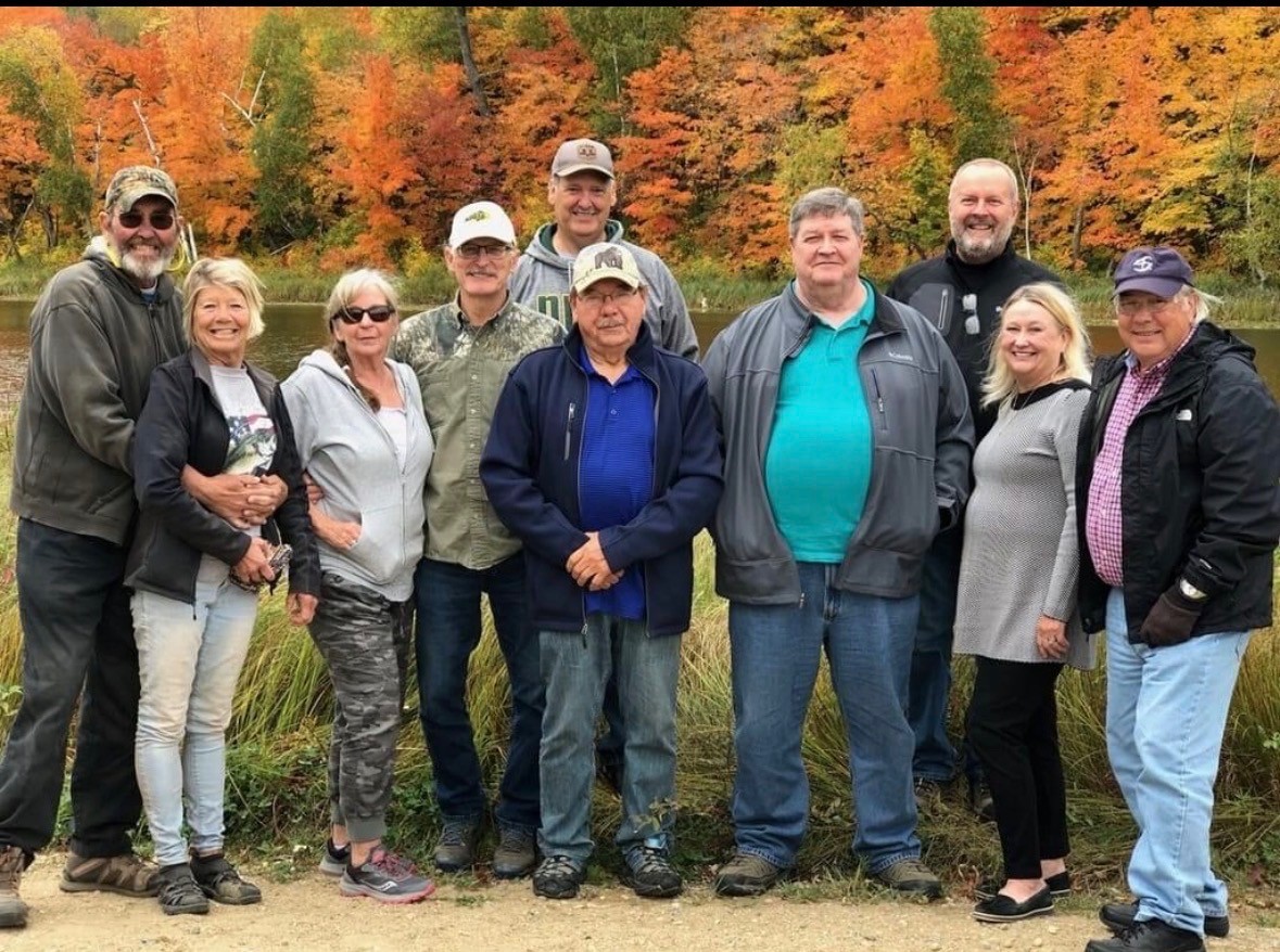 Congregation members gathered by the lake in fall