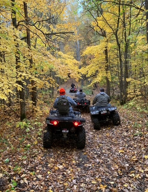 ATVs riding through fall foliage