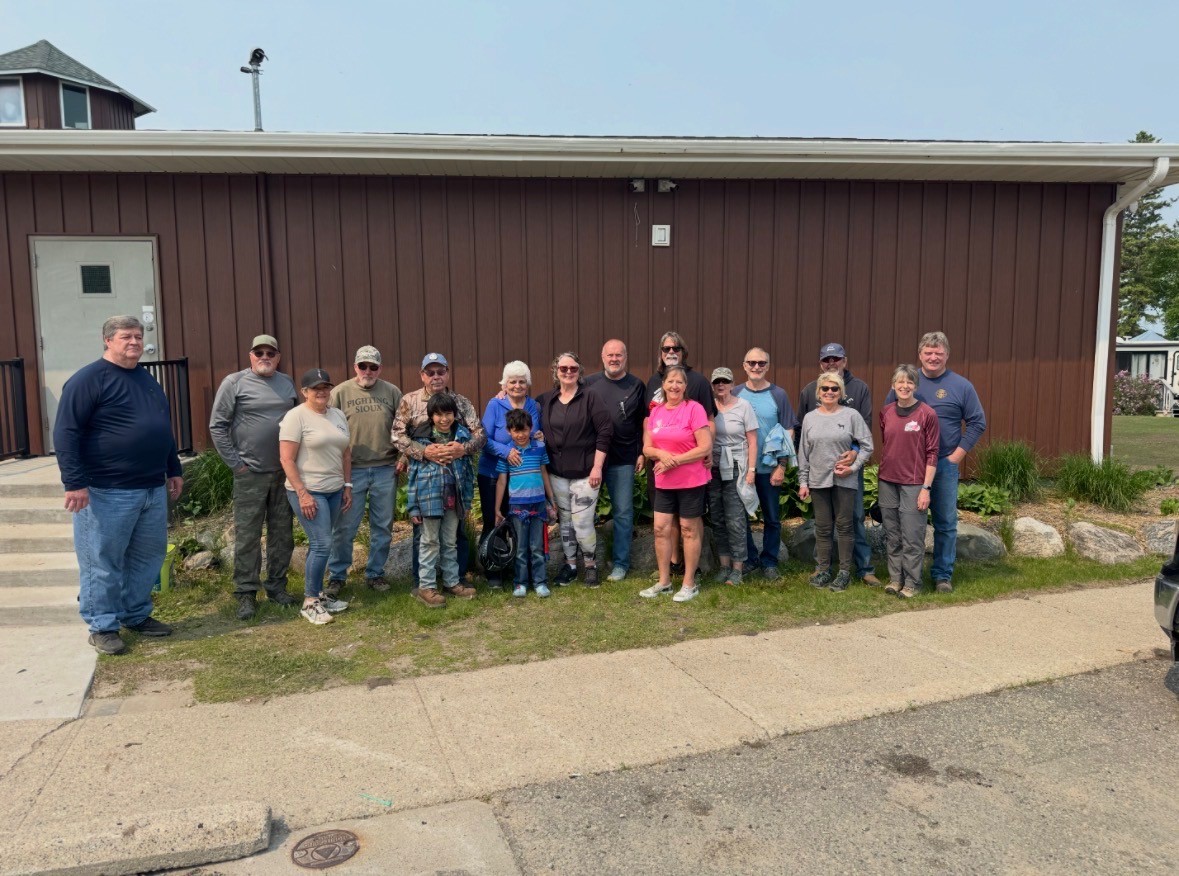 Large congregation group photo outside the church building