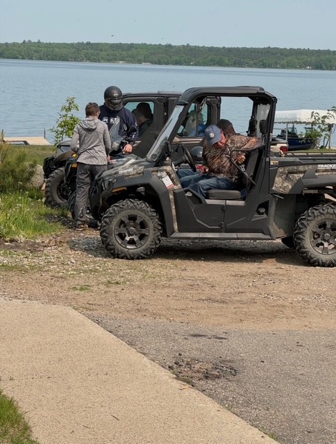ATVs parked by a lake