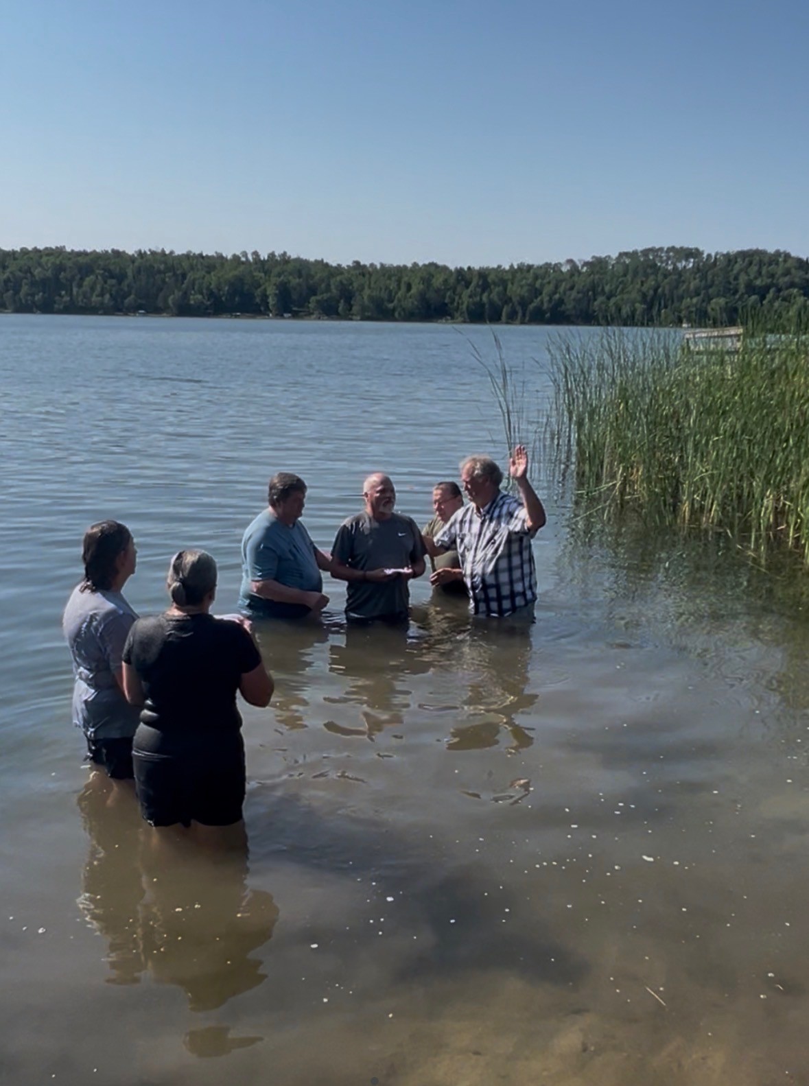 Pastor Mark performing a baptism in the lake